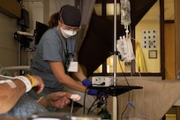 U.S. Air Force Senior Airman Katsiaryna Nelipovich, a medical technician assigned to a medical augmentation team deployed to Yuma, Arizona prepares an oxygen machine for her patient at Yuma Regional Medical Center Jan. 9, 2022.