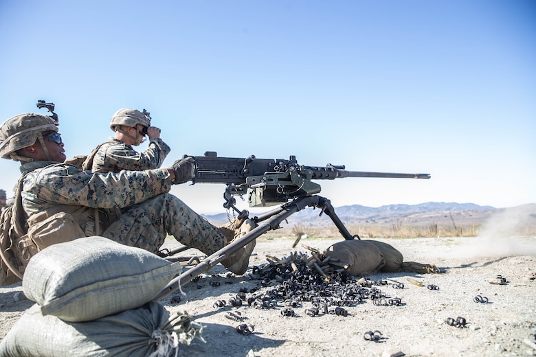 A machine gunner fires polymer rounds from a .50-caliber machine gun at Marine Corps Base Camp Pendleton, California