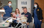 Naval Medical Center Portsmouth (NMCP) is proud to announce its First Baby of the New Year!
The first baby of 2022, Grayson, was born at 9:19 a.m., Saturday, Jan. 1. NMCP’s RN Kim Roquemore (left), along with Lt. j.g. Brandi Parks, presented Grayson’s parents, Chelsea Hoffman and Petty Officer 2nd Class Calvin Moubray, with a new-baby basket provided by the Oakleaf Club of Tidewater.