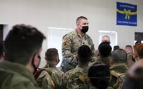 Lt. Col. Matt Braddock, commander of the 2nd Battalion, 146th Field Artillery Regiment, talks with his Soldiers before they depart Joint Base Lewis-McChord, Wash., Jan. 5, 2022. More than 100 Guard members are deploying to Poland in support of the NATO-enhanced Forward Presence mission.
