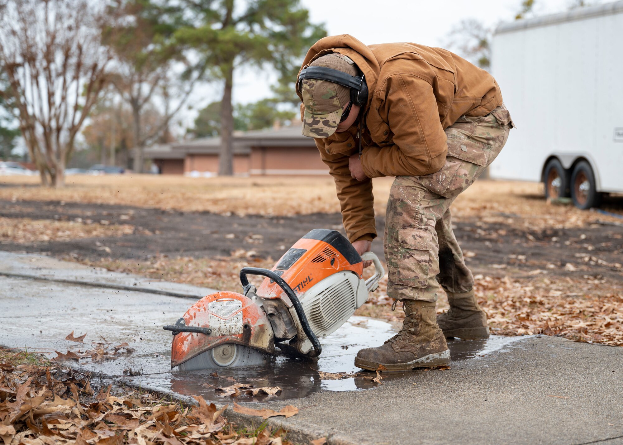 Senior Airman Aaron Smith, 4th Civil Engineer Squadron maintenance and pavement technician, uses a K-12 saw to remove an existing sidewalk at Seymour Johnson Air Force Base, North Carolina, Dec. 9, 2021.