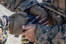 U.S. Marine  prepare ammunition for a course of fire that tests polymer-cased rounds at Marine Corps Base Camp Pendleton, California