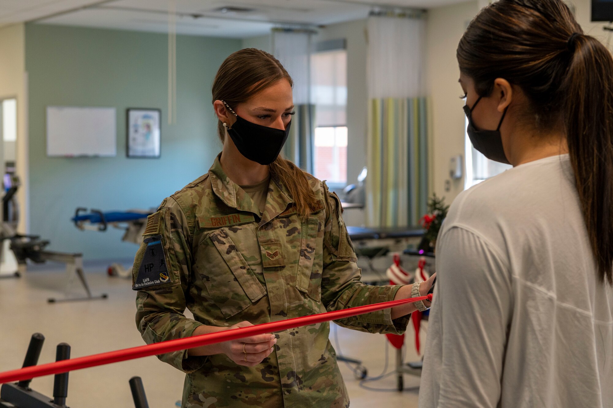 Senior Airman Mariah Griffin, left, 4th Operational Medical Readiness Squadron physical medicine technician, conducts a strengthening exercise with Staff Sgt. Andrea Villa, 4th Mission Support Group executive assistant, at Seymour Johnson Air Force Base, North Carolina, Dec. 13, 2021.