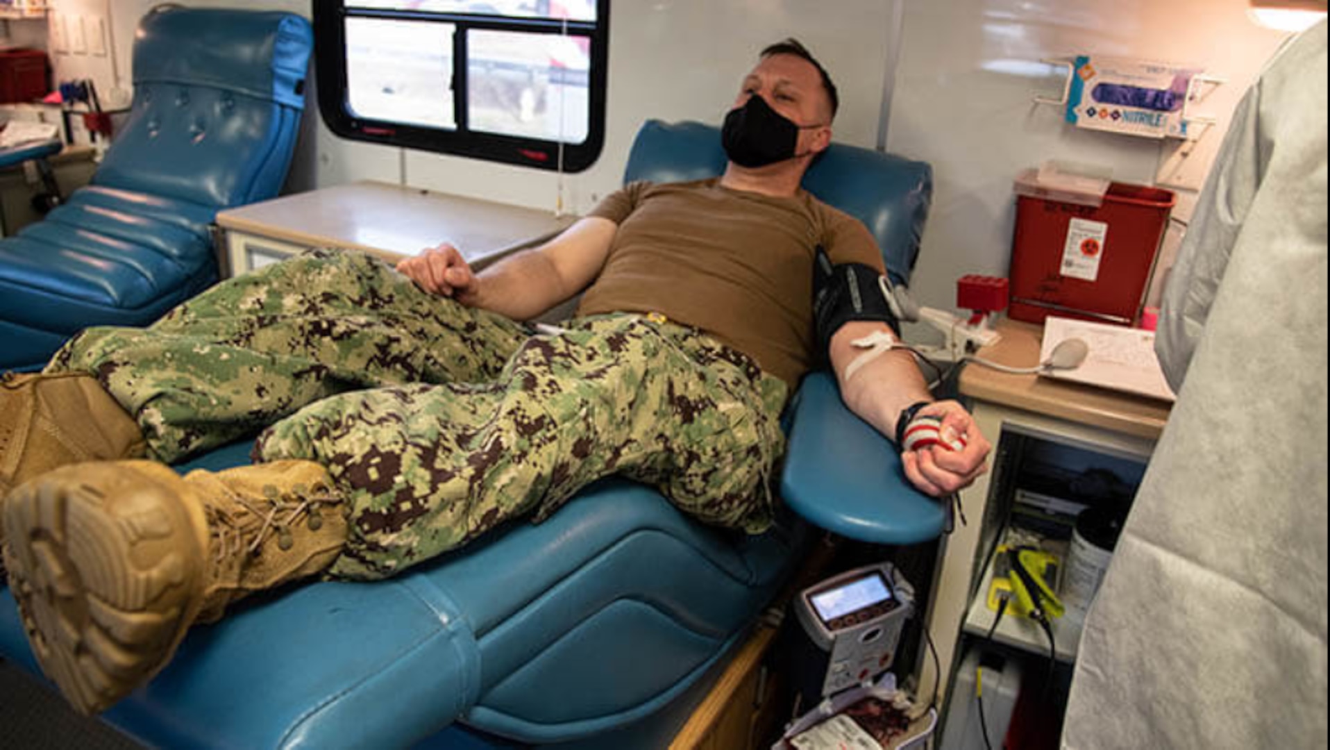 Navy Lieutenant Daniel Murrish, a Sailor serving aboard Naval Health Clinic Cherry Point, donates blood during a blood drive hosted by the Armed Services Blood Program (Photo by Thomas Cieslak)