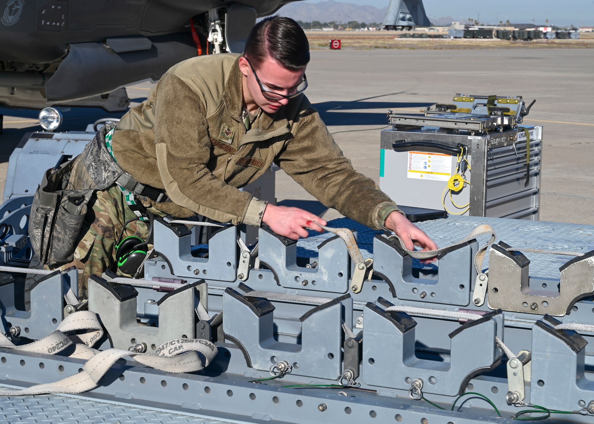 U.S. Air Force Airman 1st Class Joseph Harrison, 309th Aircraft Maintenance Unit aircraft armament system technician, prepares to load an F-35A Lightning II aircraft Jan. 7, 2022, at Luke Air Force Base, Arizona.