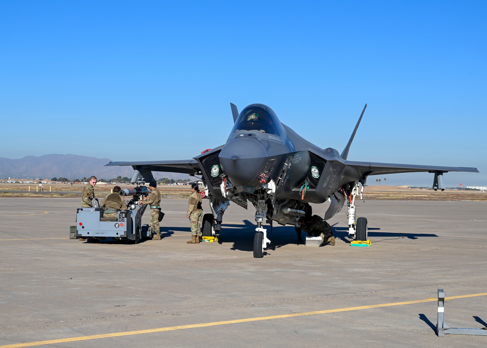 Airmen from the 308th and 309th Aircraft Maintenance Units load an AIM-120 advanced medium-range air-to-air missile on an F-35A Lightning II aircraft during a quarterly load crew competition Jan. 7, 2022, at Luke Air Force Base, Arizona.