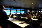 Coast Guard Capt. Kevin Carroll speaks to the U.S. and Coast Guard Cyber Commands about the importance of cyber security March 6, 2020, aboard the Spirit of Norfolk. During his speech, Carroll spoke about the challenges of maintaining a strong cyber security posture for Coast Guard Sector Virginia. (U.S. Coast Guard photo by Petty Officer 3rd Class Shannon Kearney)