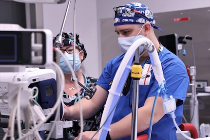 BUFFALO, N.Y. – U.S. Navy Hospital Corpsman 1st Class Curtis Cortezpoole, a clinical nurse specialist assigned to Navy Medicine Readiness and Training Command, Bethesda, Maryland, sets up equipment at the beginning of his shift while supporting COVID response operations at Erie County Medical Center, New York, Jan. 9, 2022. U.S. Northern Command, through U.S. Army North, remains committed to providing flexible Department of Defense support to the whole-of-government COVID response. (U.S. Army photo by Spc. Ashleigh Maxwell)