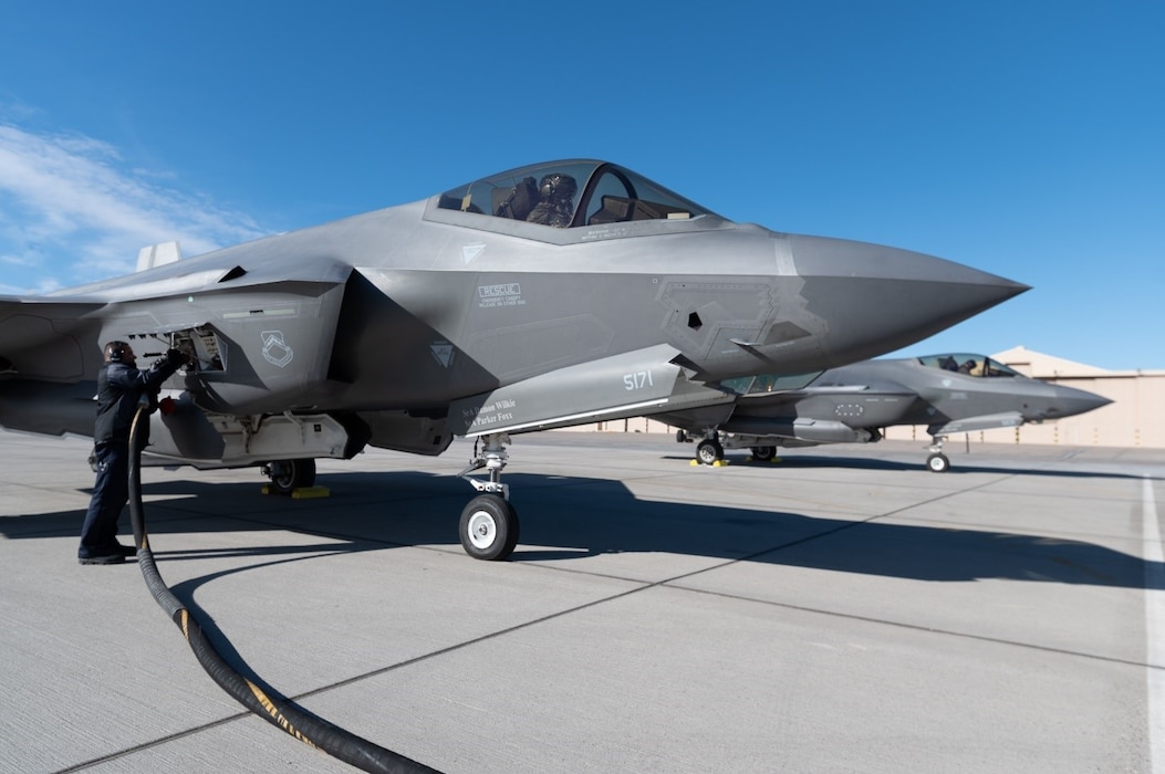 Two F-35A Lightning IIs  assigned to the 63rd Fighter Squadron refuel as they pass through a forward armament refueling point (FARP) before departing from an undisclosed location Dec. 9, 2021. Student-pilots from the 63rd Fighter Squadron recently completed a mission designed to demonstrate the U.S. Air Force’s ability to quickly compose force packages from any operational environment. (U.S. Air Force photo by Ryan Waters)