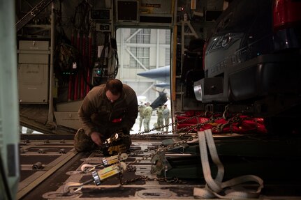 Alaska National Guard Airmen load an HC-130J Combat King II on Joint Base Elmendorf-Richardson Jan. 12, 2022, before a team of Army and Air Guardsmen depart for the Southeast Alaska community of Yakutat. Guard members serving on Joint Task Force-Yakutat will provide building safety assessments and emergency snow removal for Tribal, public and government facilities in the community following hazardous winter weather and heavy snowfall resulting in building damage and continued risk of unsafe conditions. Yakutat is in the Tongass National Forest, the largest National Forest in the U.S. and home to the largest population of bald eagles in the world. The Alaska National Guard is trained, equipped and ready to provide disaster response support for the State of Alaska when requested by civil authorities. (U.S. Army National Guard photo by Spc. Grace Nechanicky)