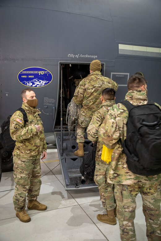 Alaska National Guard Soldiers and Airmen board an HC-130J Combat King II on Joint Base Elmendorf-Richardson Jan. 12, 2022, before departing for the Southeast Alaska community of Yakutat. Guard members serving on Joint Task Force-Yakutat will provide building safety assessments and emergency snow removal for Tribal, public and government facilities in the community following hazardous winter weather and heavy snowfall resulting in building damage and continued risk of unsafe conditions. Yakutat is in the Tongass National Forest, the largest National Forest in the U.S. and home to the largest population of bald eagles in the world. The Alaska National Guard is trained, equipped and ready to provide disaster response support for the State of Alaska when requested by civil authorities. (U.S. Army National Guard photo by Spc. Grace Nechanicky)