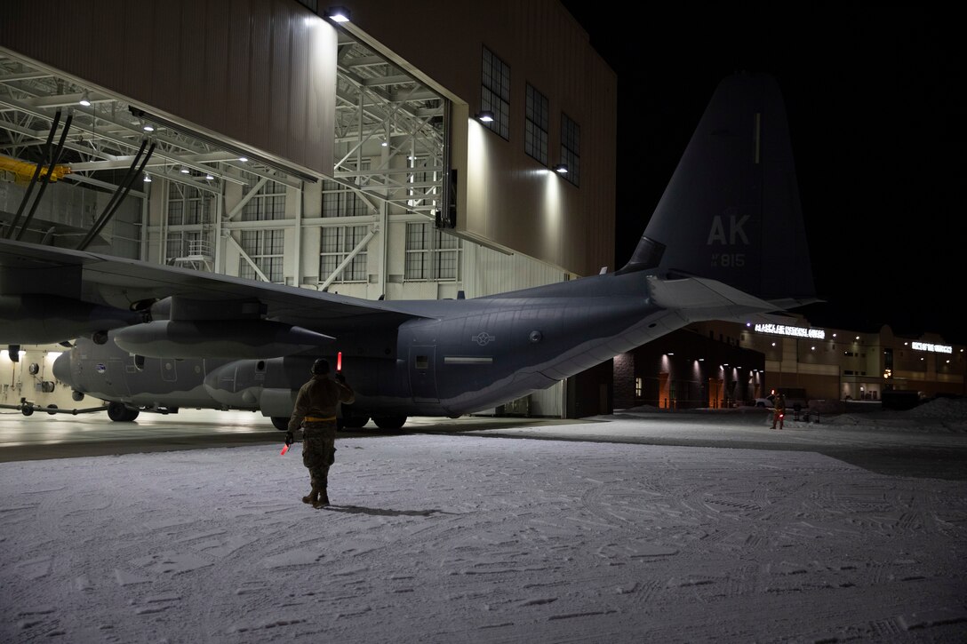 Alaska National Guard Soldiers and Airmen aboard an HC-130J Combat King II on Joint Base Elmendorf-Richardson Jan. 12, 2022, depart for the Southeast Alaska community of Yakutat. Guard members serving on Joint Task Force-Yakutat will provide building safety assessments and emergency snow removal for Tribal, public and government facilities in the community following hazardous winter weather and heavy snowfall resulting in building damage and continued risk of unsafe conditions. Yakutat is in the Tongass National Forest, the largest National Forest in the U.S. and home to the largest population of bald eagles in the world. The Alaska National Guard is trained, equipped and ready to provide disaster response support for the State of Alaska when requested by civil authorities. (U.S. Army National Guard photo by Spc. Grace Nechanicky)