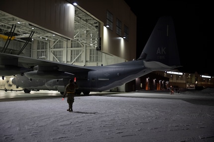 Alaska National Guard Soldiers and Airmen aboard an HC-130J Combat King II on Joint Base Elmendorf-Richardson Jan. 12, 2022, depart for the Southeast Alaska community of Yakutat. Guard members serving on Joint Task Force-Yakutat will provide building safety assessments and emergency snow removal for Tribal, public and government facilities in the community following hazardous winter weather and heavy snowfall resulting in building damage and continued risk of unsafe conditions. Yakutat is in the Tongass National Forest, the largest National Forest in the U.S. and home to the largest population of bald eagles in the world. The Alaska National Guard is trained, equipped and ready to provide disaster response support for the State of Alaska when requested by civil authorities. (U.S. Army National Guard photo by Spc. Grace Nechanicky)