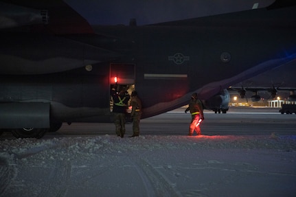 Alaska National Guard Soldiers and Airmen aboard an HC-130J Combat King II on Joint Base Elmendorf-Richardson Jan. 12, 2022, depart for the Southeast Alaska community of Yakutat. Guard members serving on Joint Task Force-Yakutat will provide building safety assessments and emergency snow removal for Tribal, public and government facilities in the community following hazardous winter weather and heavy snowfall resulting in building damage and continued risk of unsafe conditions. Yakutat is in the Tongass National Forest, the largest National Forest in the U.S. and home to the largest population of bald eagles in the world. The Alaska National Guard is trained, equipped and ready to provide disaster response support for the State of Alaska when requested by civil authorities. (U.S. Army National Guard photo by Spc. Grace Nechanicky)