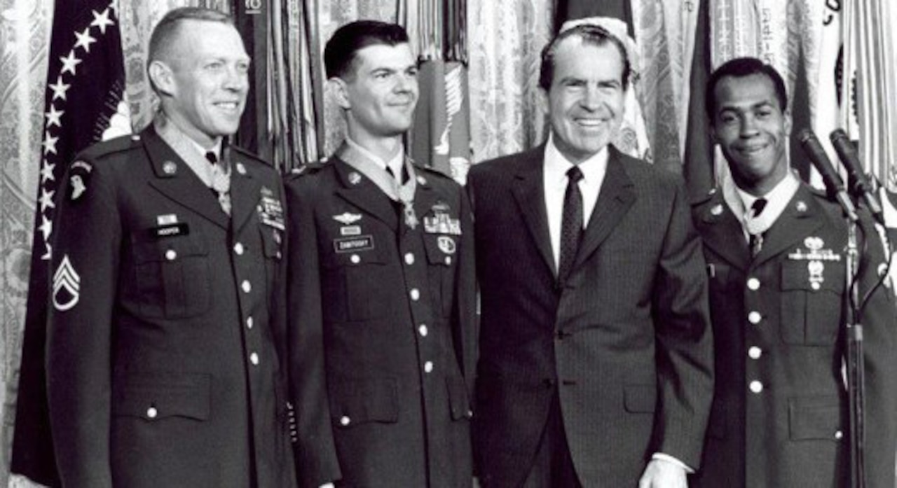 Four men stand together for a photo opportunity.