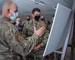 U.S. Air Force Lt. Gen. A. Michael Loh, center, director of the Air National Guard, is briefed on the recent tornado-response operations of the 123rd Special Tactics Squadron during a tour at the Kentucky Air National Guard Base in Louisville, Kentucky, Jan. 8, 2022. Loh also held a town hall-style meeting and fielded questions from Kentucky Airmen.