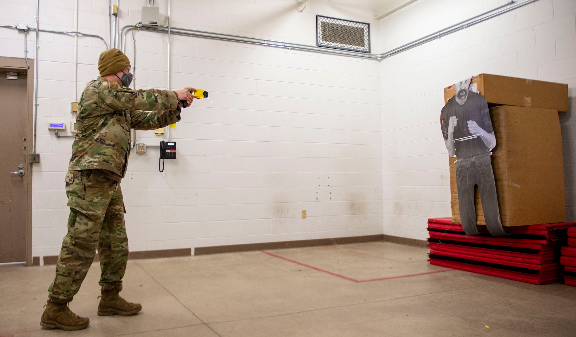 U.S. Air Force Staff Sgt. Jeffrey Fouts, 133rd Security Forces Squadron, fires a Taser at a paper target in St. Paul, Minn., Jan. 07, 2022.