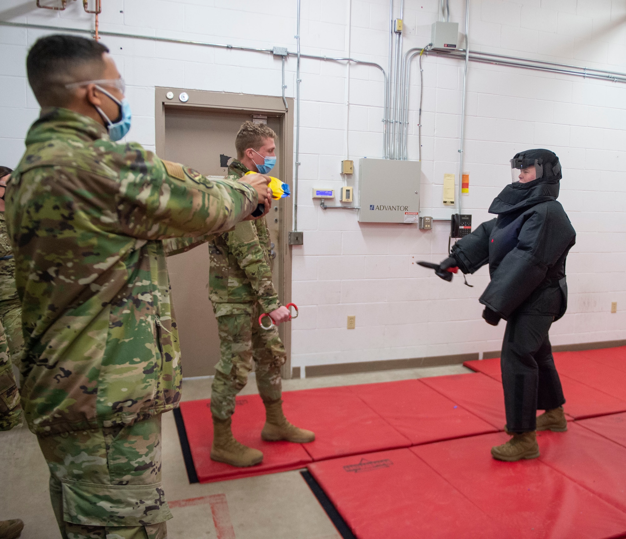 U.S. Air Force Senior Airman Jordan Hopwood, left, and Airman 1st Class Benjamin Brama, right, 133rd Security Forces Squadron, attempt to de-escalate and handcuff simulated aggressor Staff Sgt. Jeffrey Fouts in St. Paul, Minn., Jan. 07, 2022.