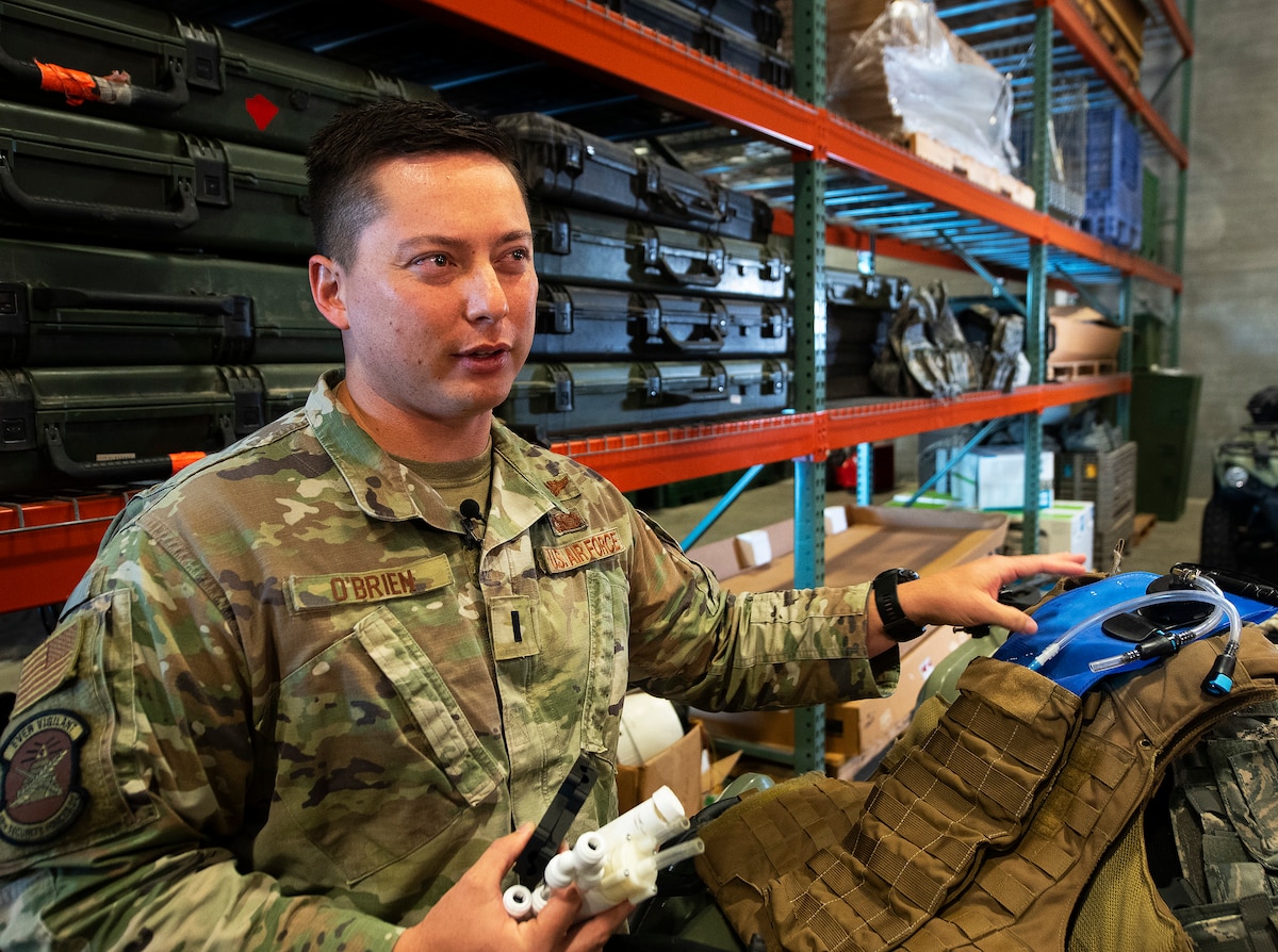 First Lt. Justin O’Brien, 88th Security Forces Squadron, explains features of the liquid-cooled plate carrier during an interview Sept. 24, 2021, at Wright-Patterson Air Force Base, Ohio. He designed the carrier as a way of cooling “Defenders” wearing body armor. (U.S. Air Force photo by R.J. Oriez)