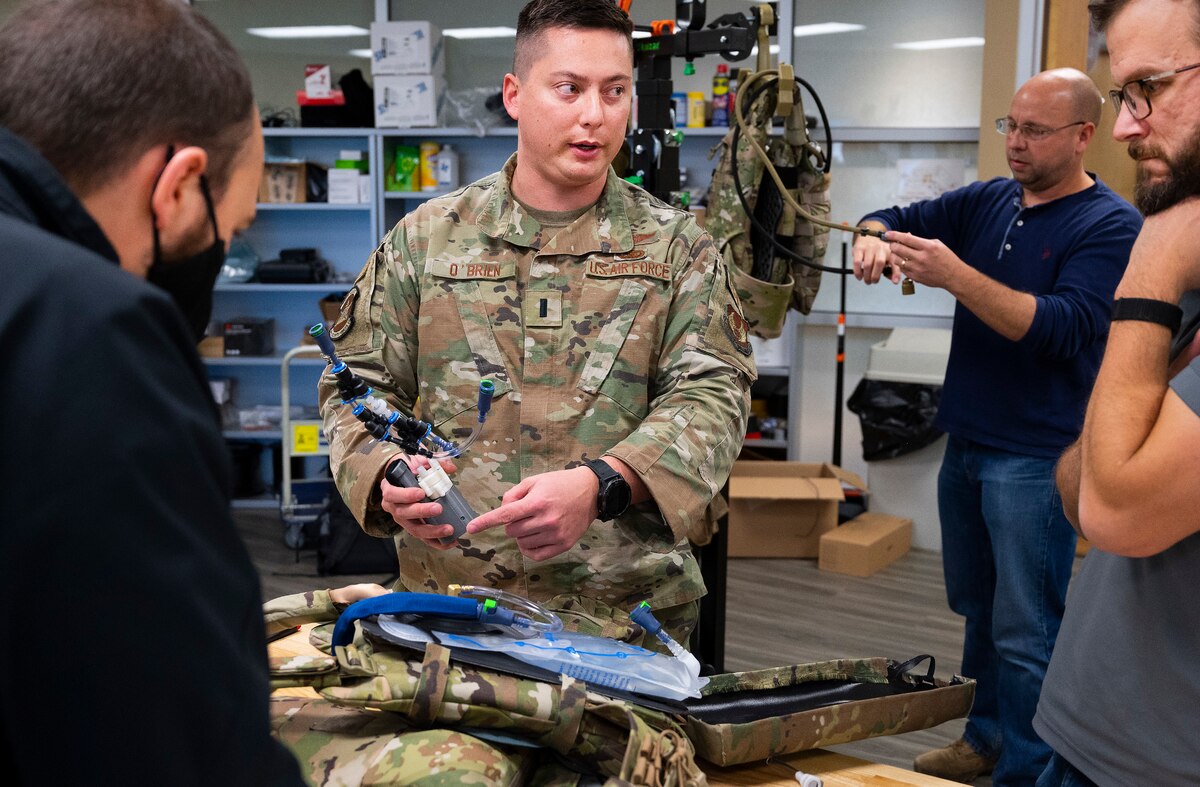 First Lt. Justin O’Brien, 88th Security Forces Squadron, consults with Wright Brothers Institute and Air Force Research Laboratory engineers Dec. 1, 2021, as they build a prototype of the liquid-cooled plate carrier. O’Brien entered his design in Air Force Materiel Command’s Spark Tank competition, catching the attention Air Force leadership. (U.S. Air Force photo by R.J. Oriez)