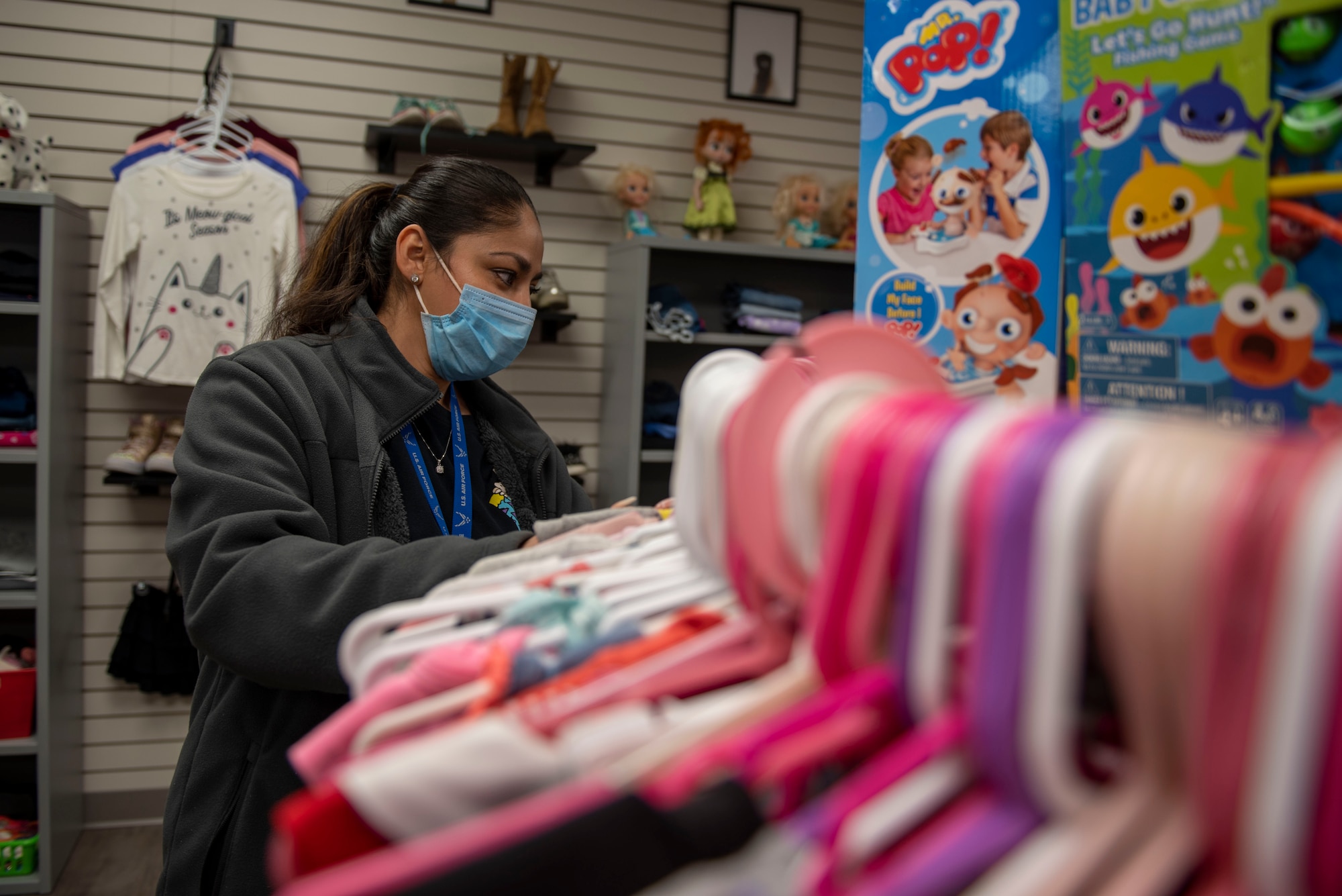 Alma Lorera, the Airman’s Attic volunteer coordinator, organizes children's clothing at the Airman’s Attic at Seymour Johnson Air Force Base, N.C., Jan. 6, 2022. The Airman’s Attic is a community based program that is run on volunteer support. (U.S Air Force photo by Airman 1st Class Sabrina Fuller)