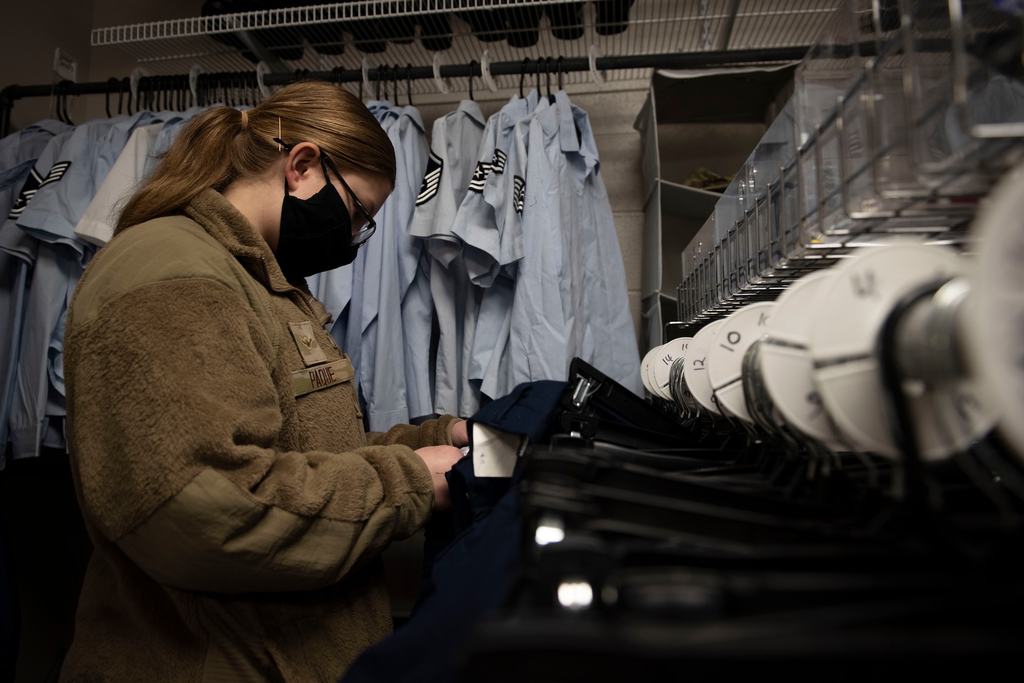 Airman Abigail Paque, 4th Fighter Wing paralegal, shops for service dress uniforms at the Airman’s Attic at Seymour Johnson Air Force Base, N.C., Jan. 6, 2022. Some of the supplies provided to the Airman’s Attic are recycled from other Airmen either due to permanent change of station, deployment or just downsizing. (U.S Air Force photo by Airman 1st Class Sabrina Fuller)