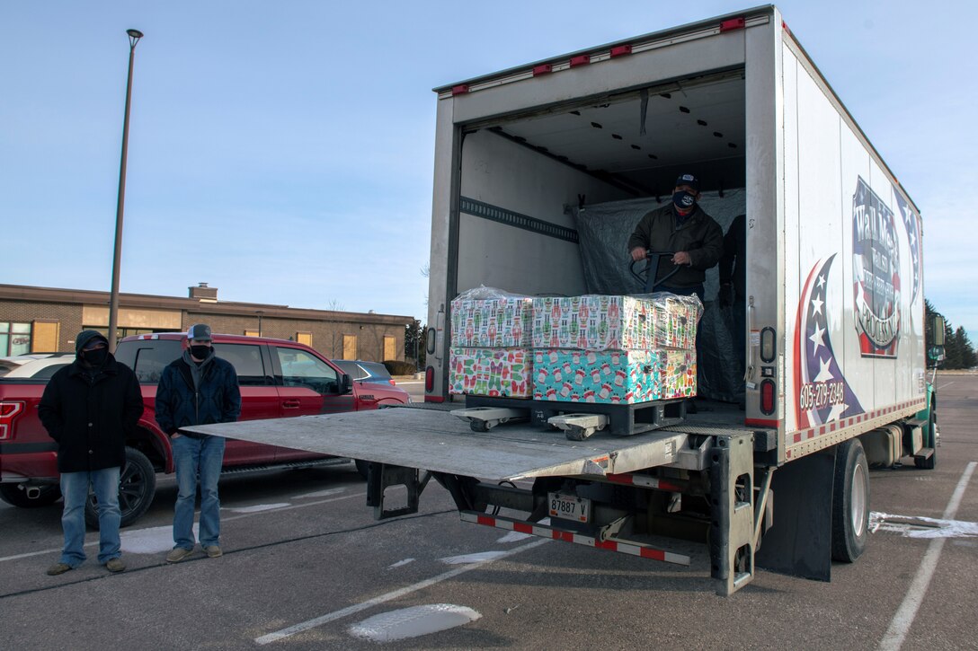 Local civilians from Circle-E Beef and Wall Meat, unload meat to be donated at Ellsworth Air Force Base, S.D., Jan. 6, 2022.