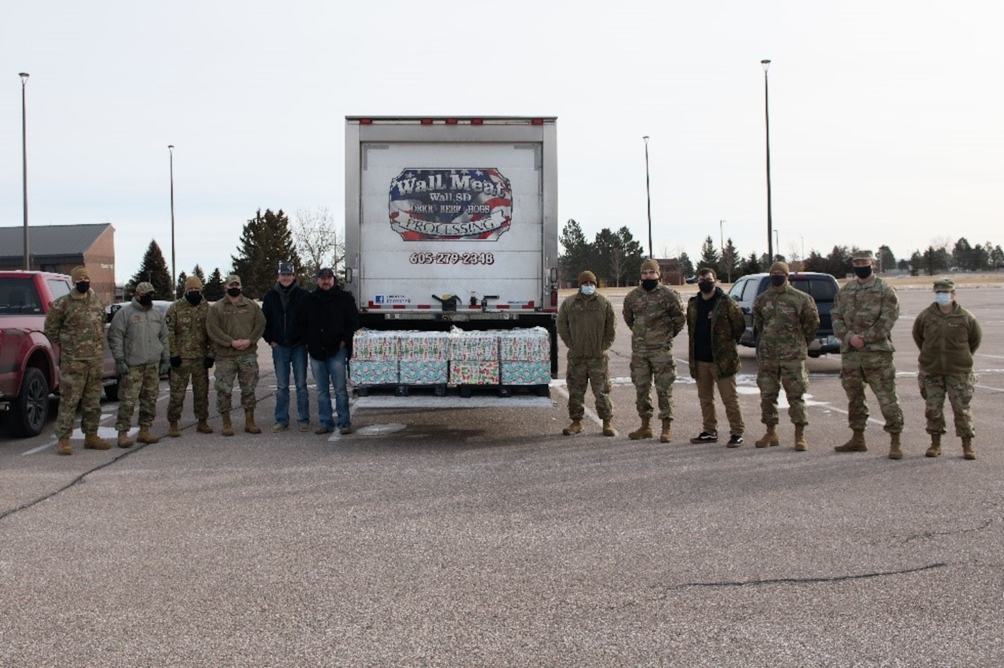 A group of airmen, along with two visiting civilians, prepare to distribute donations at Ellsworth Air force Base, S.D., Jan. 6, 2022.