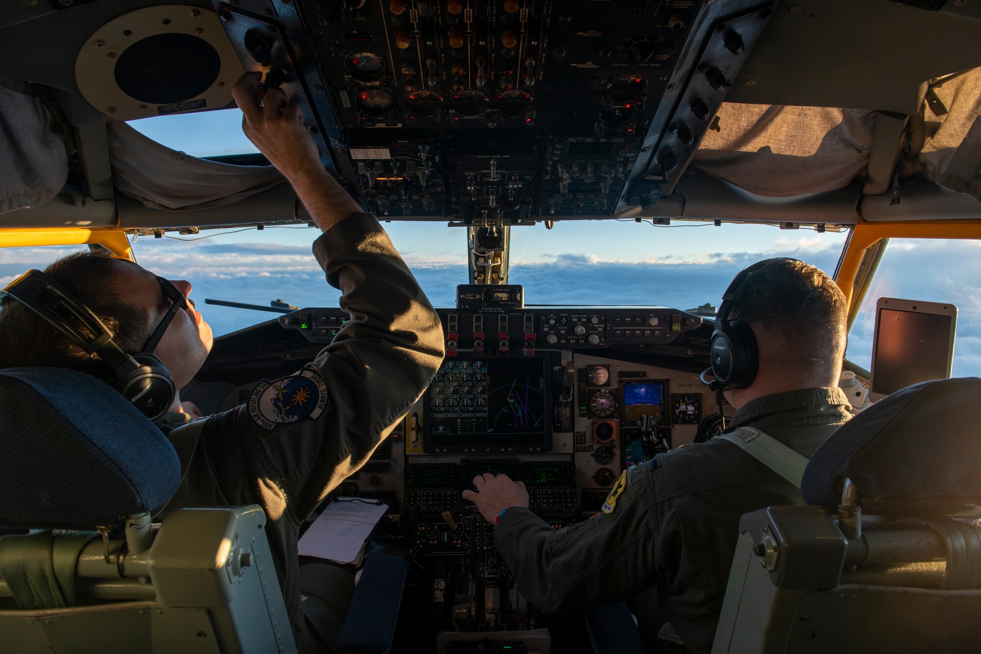 U.S. Air Force Capt. Austin Martin, 909th Air Refueling Squadron aircraft commander, left, and 1st Lt. Kyle Weinell, 909th Air Refueling Squadron pilot, operate a KC-135R Stratotanker during refueling over the Pacific Ocean in support of a Bomber Task Force mission, Jan. 11, 2022. The 909th ARS supported the BTF, which aligns with the National Defense Strategy’s objectives of strategic predictability and operational unpredictability. (U.S. Air Force photo by Airman 1st Class Moses Taylor)