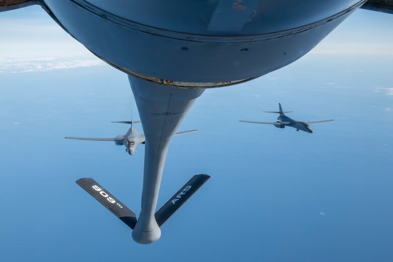 Two B-1B Lancers from the 7th Bomb Wing, Dyess Air Force Base, Texas, fly behind a KC-135R Stratotanker after receiving fuel over the Pacific Ocean during a Bomber Task Force mission, Jan. 11, 2022. During the mission, the B-1 integrated with Japan Air Self-Defense Force aircraft to conduct intercept, formation and navigation training. (U.S. Air Force photo by Airman 1st Class Moses Taylor)