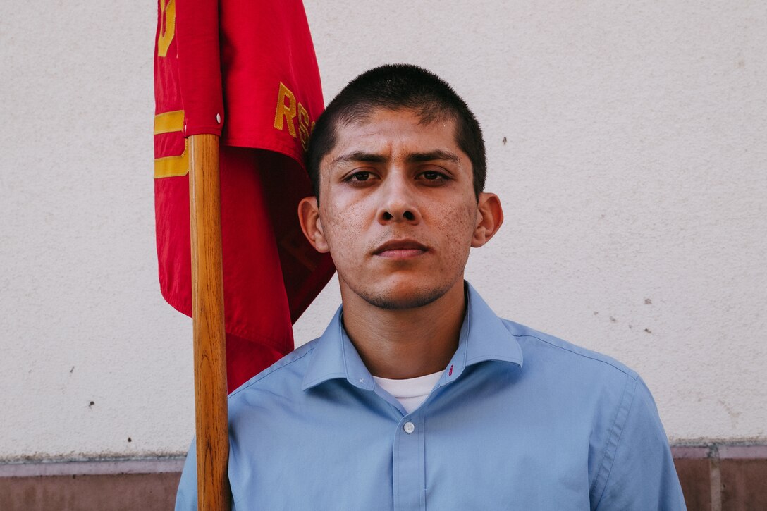 Oscar Medina, a future Marine with Recruiting Sub-Station Fullerton, Recruiting Station Orange County, stands at the position of attention with the RSS guidon in Fullerton, California on October 5, 2021. Receiving the billet as Guide is an important role to have, whether in the Delayed Entry Program or in recruit training. When you are a Guide, you become the liaison between Marines and future Marines, or between Marines and recruits.  (U.S. Marine Corps photo by Sgt. Sarah Ralph)