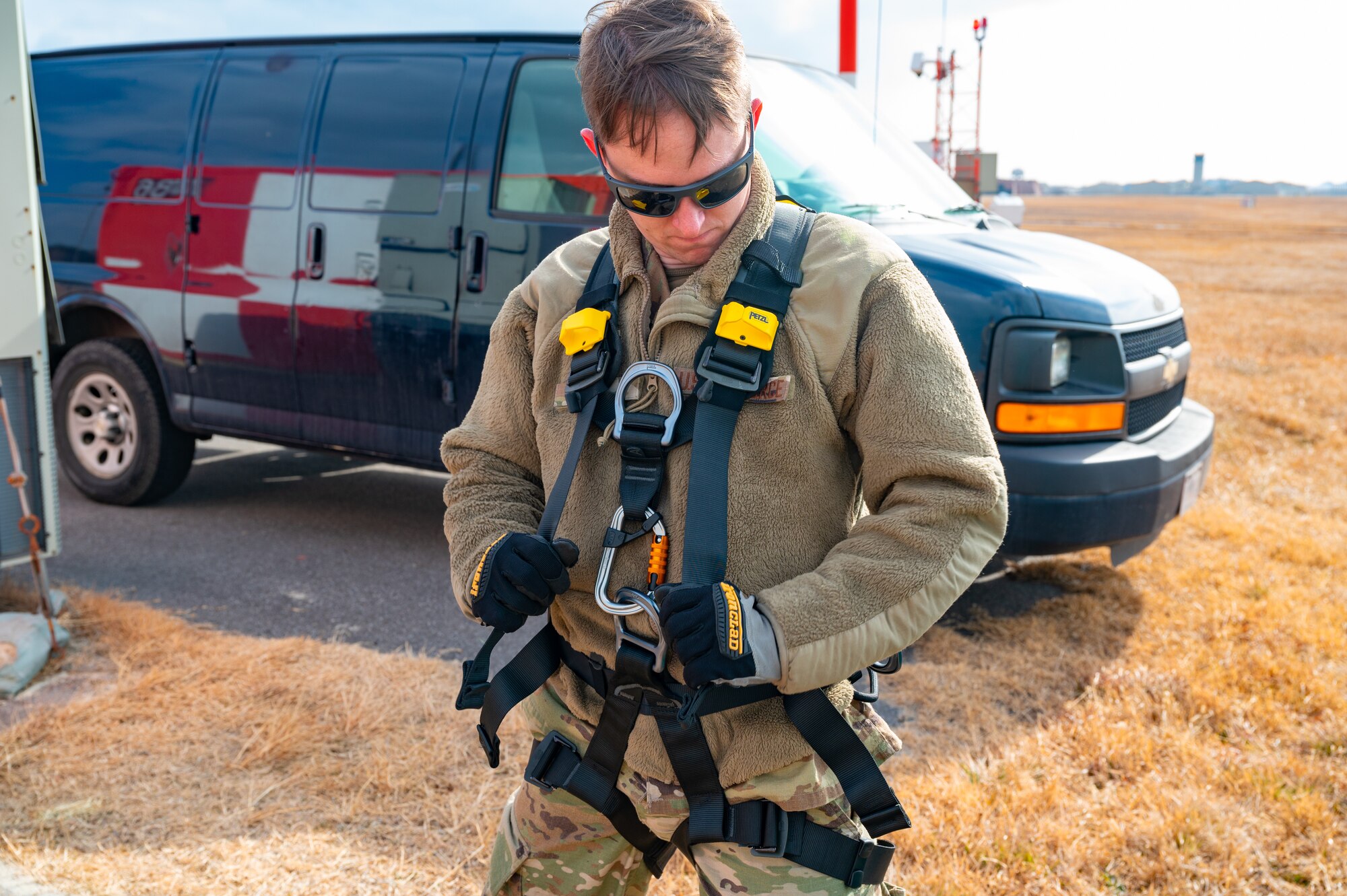 RAWS technicians inspect wire connections on glide slope antenna tower.