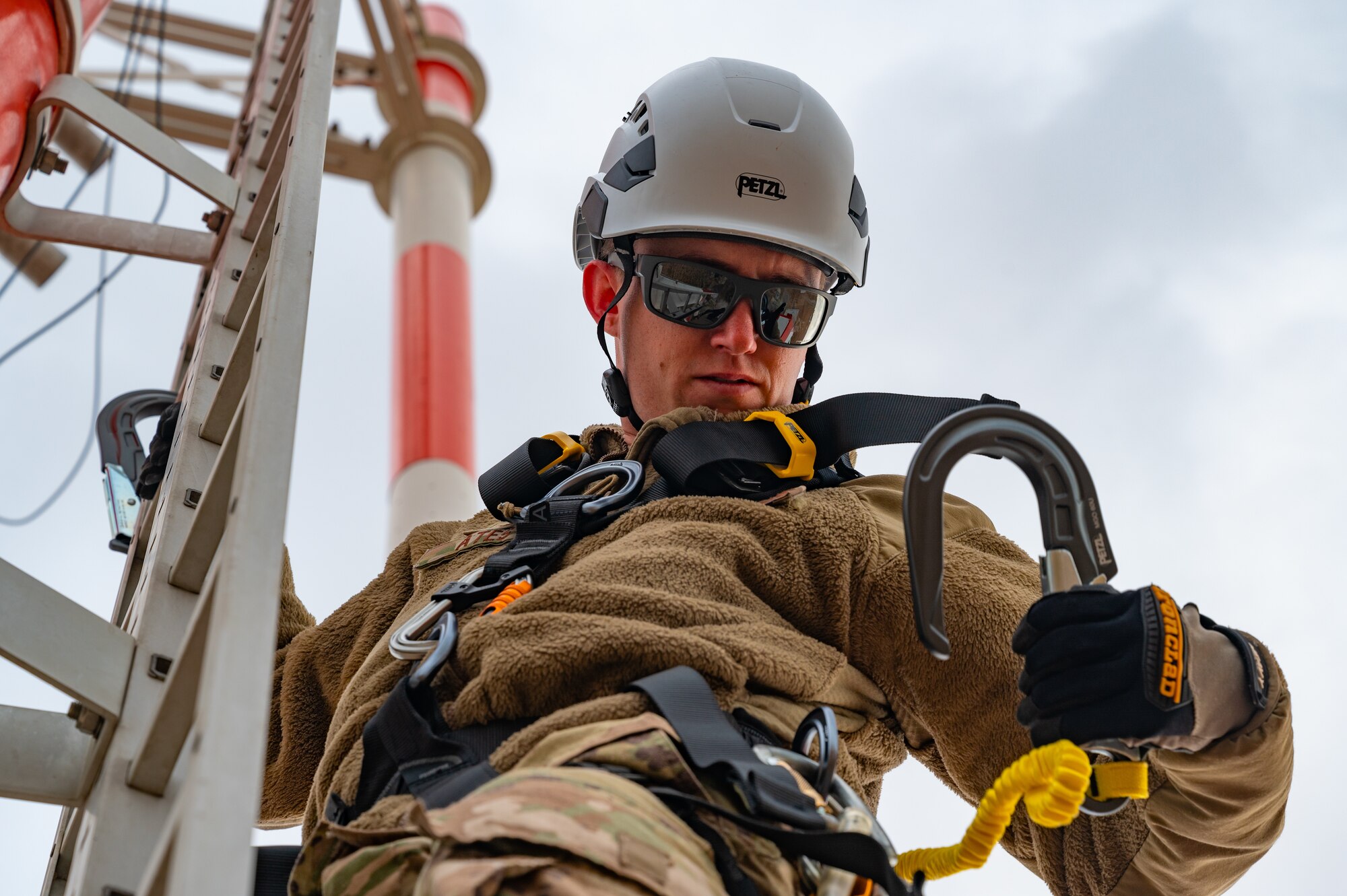 RAWS technicians inspect wire connections on glide slope antenna tower.