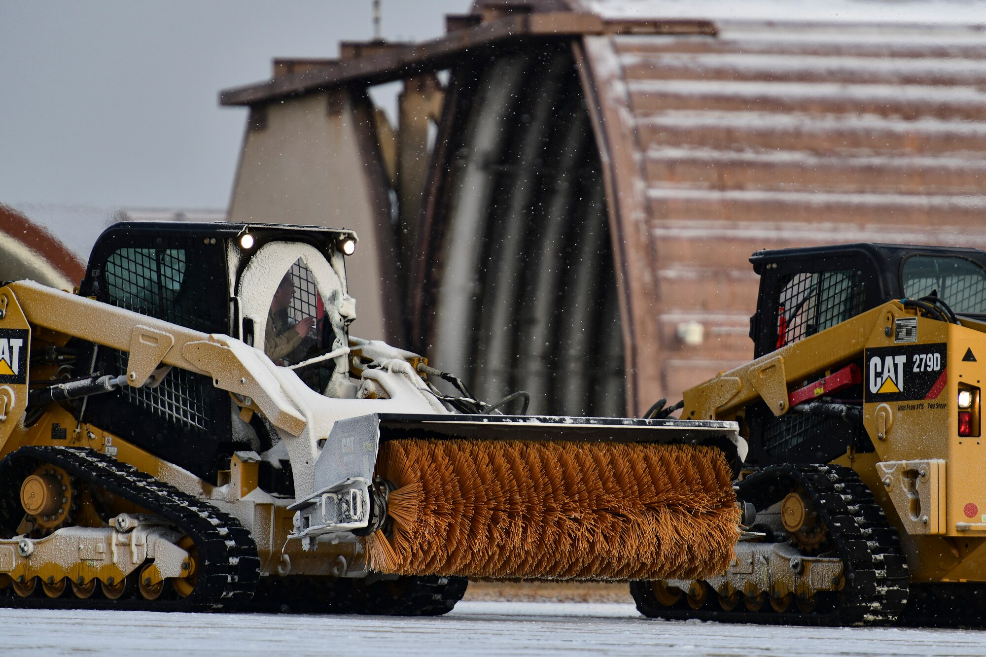 An Airman removes snow on the flightline.