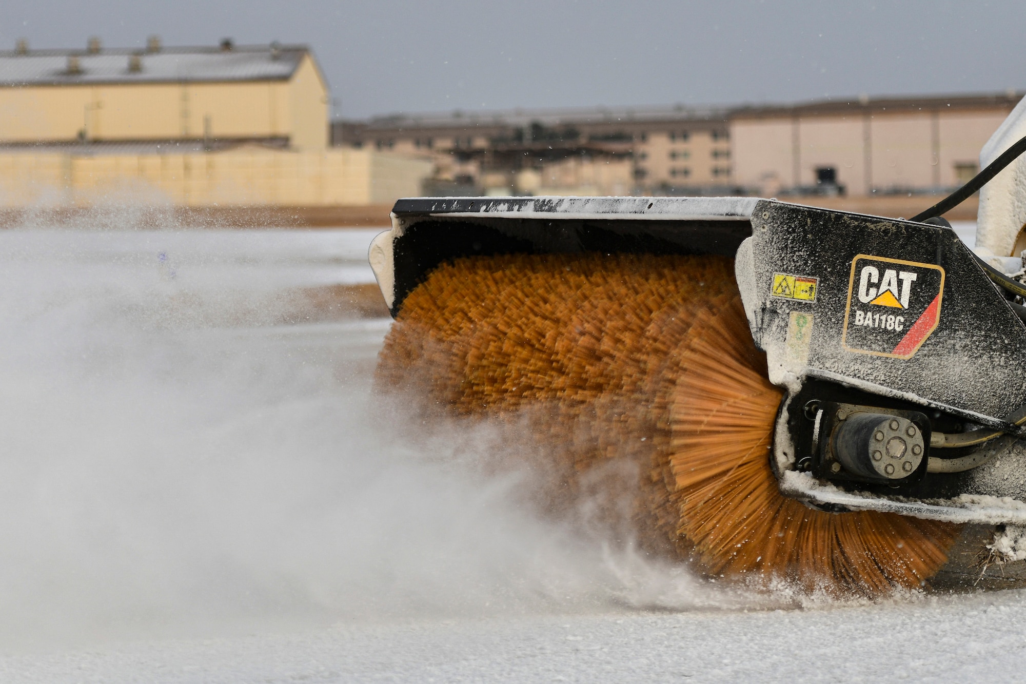 An Airman removes snow on the flightline.