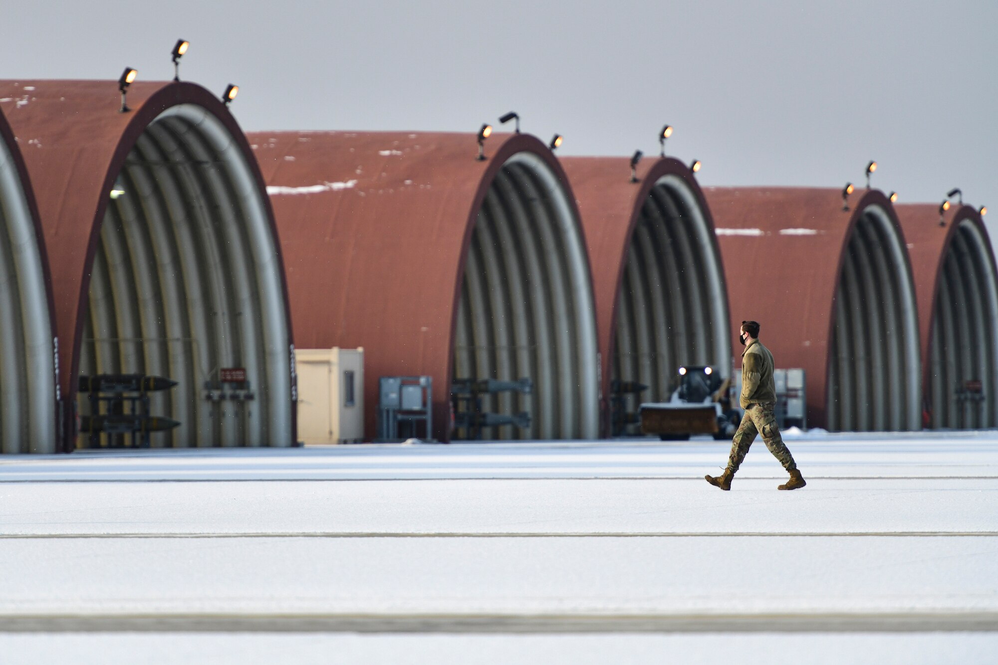 An Airman removes snow on the flightline.