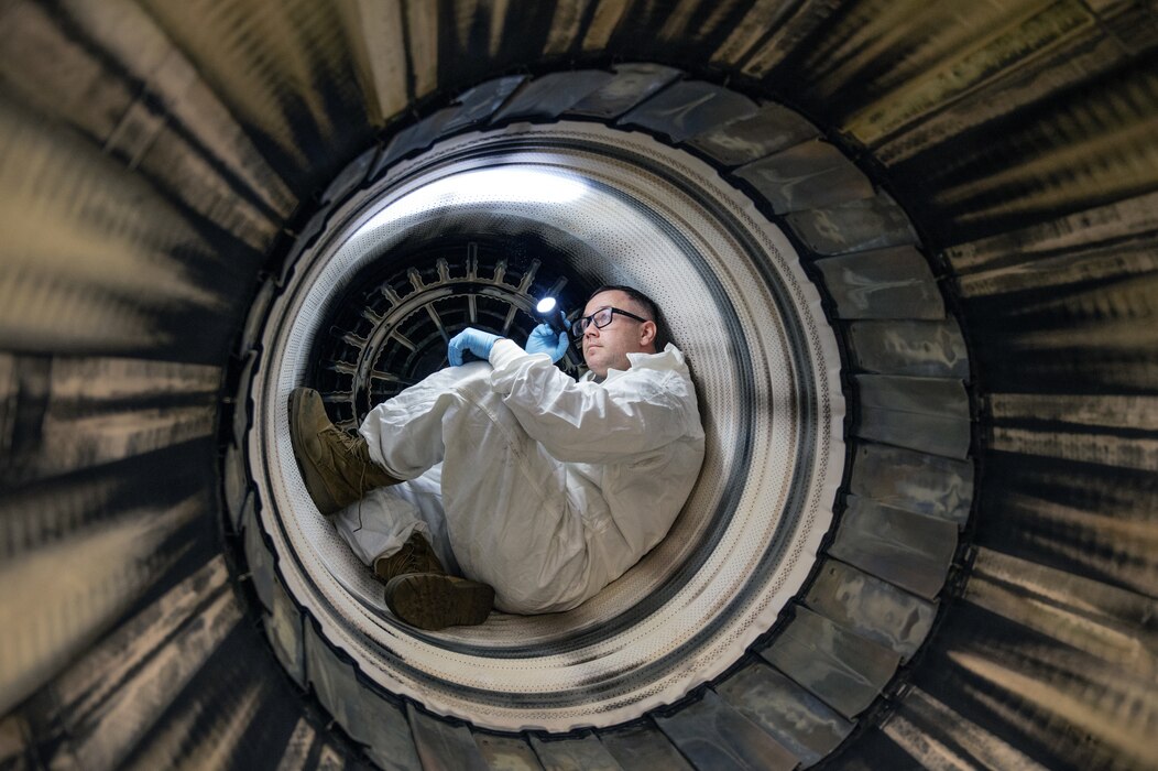 Tech. Sgt. Justin St Thomas inspects the liner of an F-16 Fighting Falcon jet engine