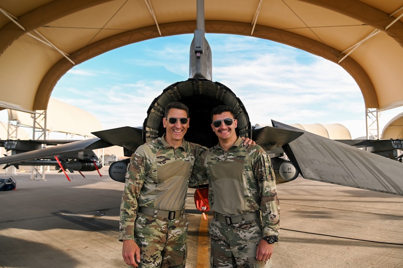 Two airmen pose for a photo.