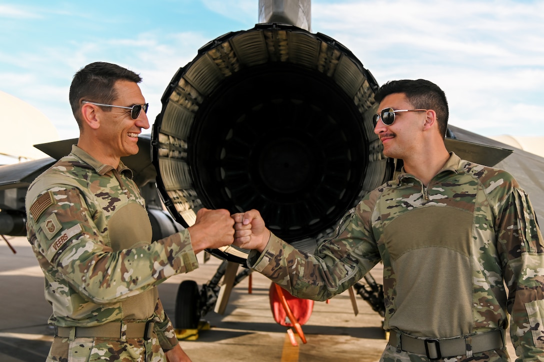 Two airmen pose for a photo.