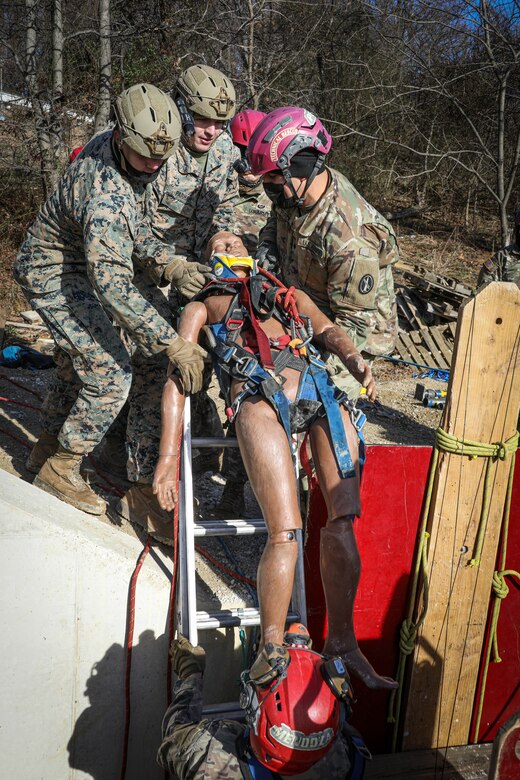 District of Columbia, (Jan 11, 2022) – U.S. Marines from Chemical Biological Incident Response Force (CBIRF) along with U.S. Army Soldiers from the 911th Technical Rescue Engineer Company participate in Joint technical rescue training using a trench trainer at the DC Fire Training Academy in Washington D.C. on January 11, 2022. CBIRF trains with various units and locations year-round in order to maintain maximum effectiveness for both the unit itself, and everyone else in the CBRNE mission set. Technical rescue is a vital component of CBRNE response, as Marines and Soldiers could potentially have to stabilize structures to provide aid. (Official U.S. Marine Corps photo by Gunnery Sgt. Kristian S. Karsten/Released)