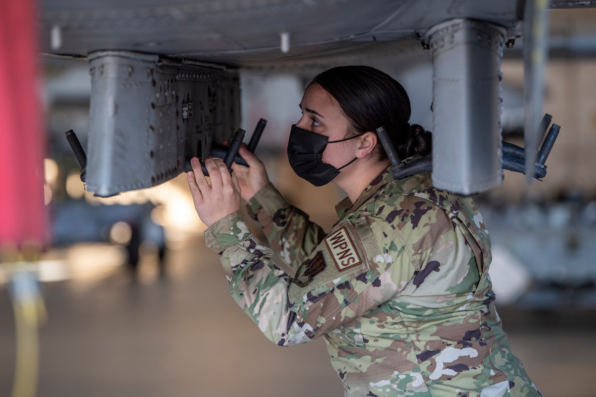 Photo of Airman working on aircraft