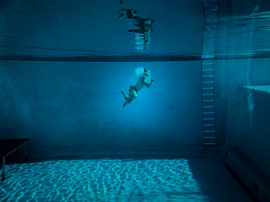 U.S. Marine Corps Sgt. John Peters, an explosive ordnance disposal technician with 1st Explosive Ordnance Disposal Company, 7th Engineer Support Battalion, 1st Marine Logistics Group, swims laps during a water confidence training exercise with Marines from 3rd MLG on Camp Pendleton, Calif. Nov. 11, 2021. Marines use this as a training method to increase underwater confidence in preparation for expeditionary missions.