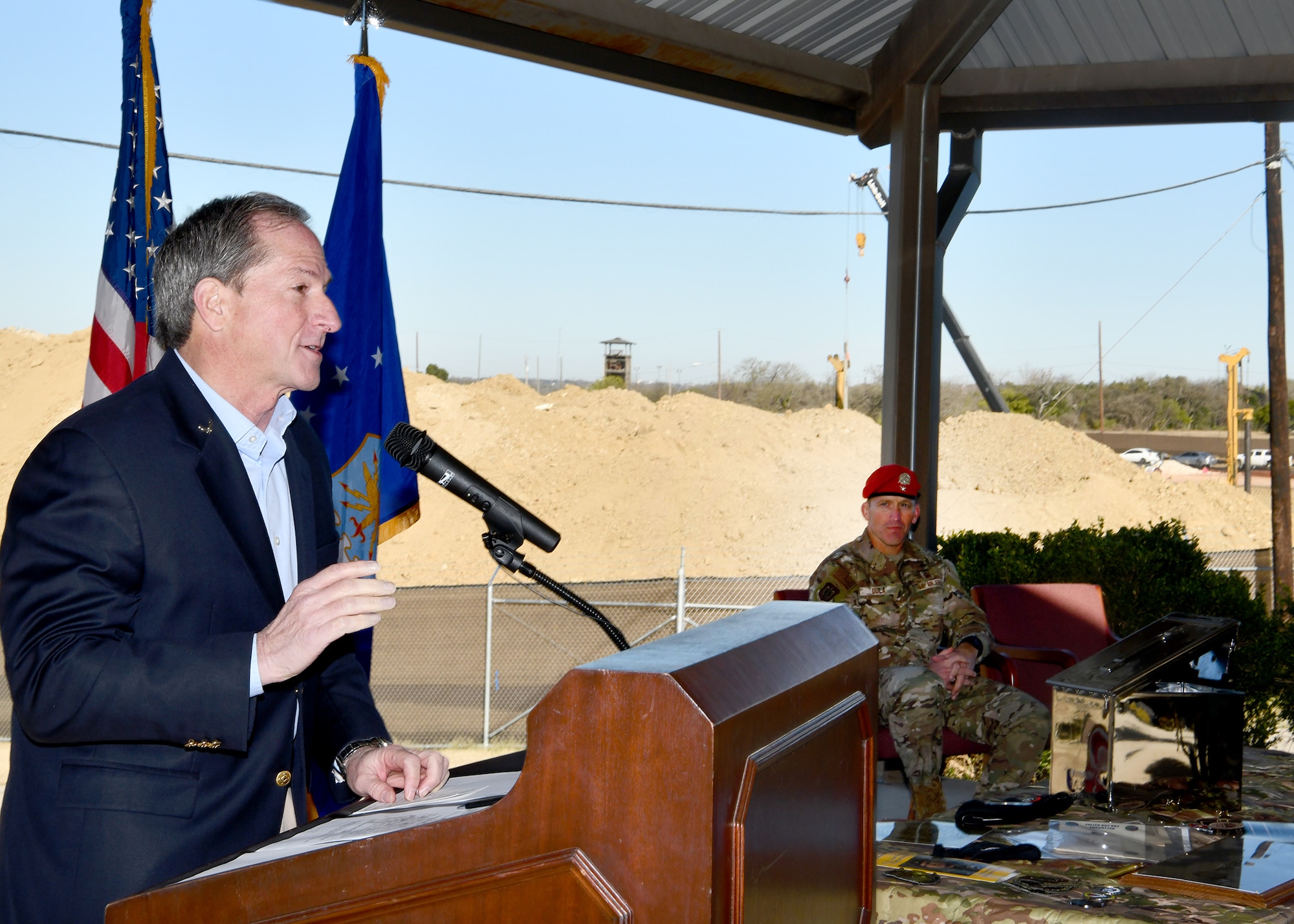 Former U.S. Air Force Chief of Staff Gen. David Goldfein (ret.) speaks at the Special Warfare Training Wing prior to placing an item in the SWTW aquatics training center heritage capsule while standing in front of the future site of the SWTW aquatics training facility while U.S. Air Force Col. Mason R. Dula, SWTWE, commander listens