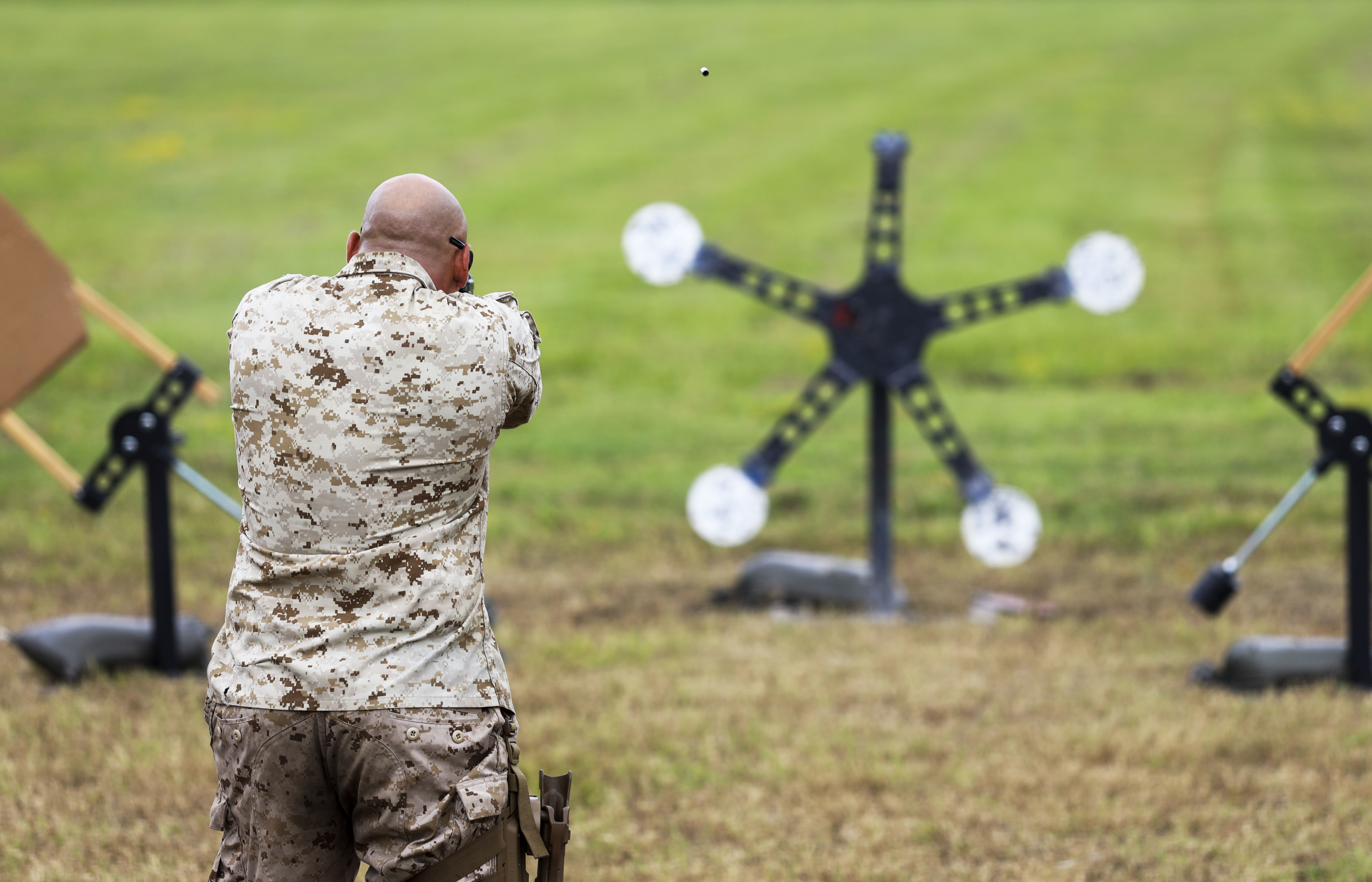 A Marine from behind practicing target shooting.
