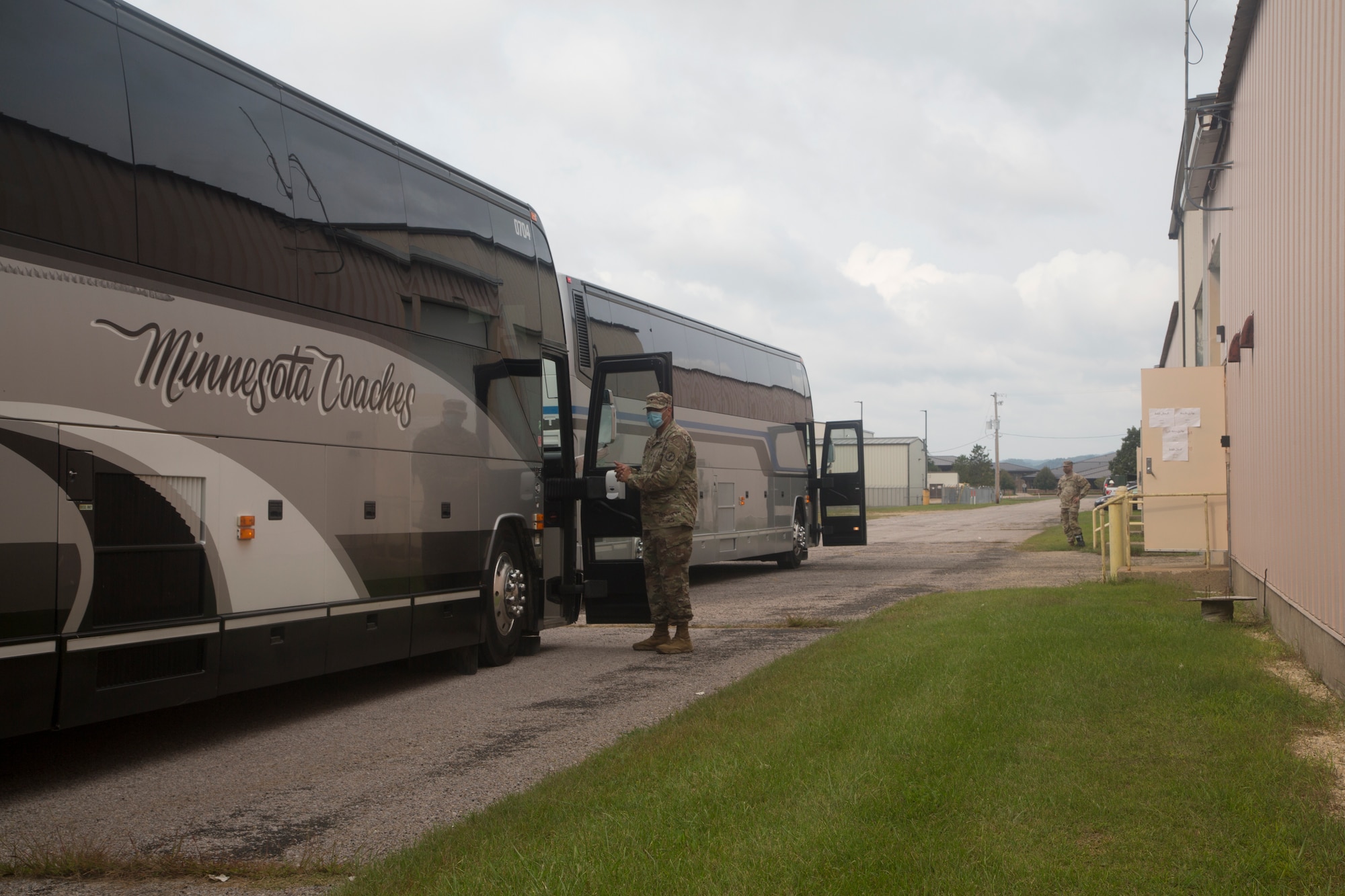 Buses filled with Afghan evacuees line up outside a clothing distribution center during Operation Allies Welcome at Fort McCoy, Wisconsin, Sept. 7, 2021. The Department of Defense, through U.S. Northern Command, and in support of the Department of Homeland Security, is providing transportation, temporary housing, medical screening, and general support for at least 50,000 Afghan evacuees at suitable facilities, in permanent or temporary structures, as quickly as possible. This initiative provides Afghan personnel essential support at secure locations outside Afghanistan (U.S. Army photo by Spc. Eric Cerami/ 55th Signal Company)