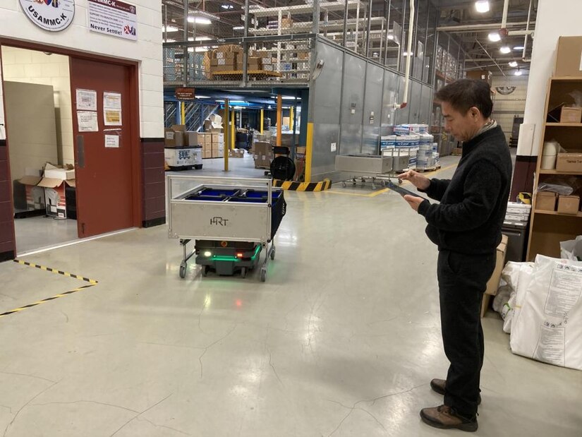 A worker at the U.S. Army Medical Materiel Center-Korea operates a new robotics carrier system to transport customer orders in the USAMMC-K warehouse. The system has increased efficiency and reduced manpower needs for processing orders for medical supply. (U.S. Army by Master Sgt. Rizmel Paguio)