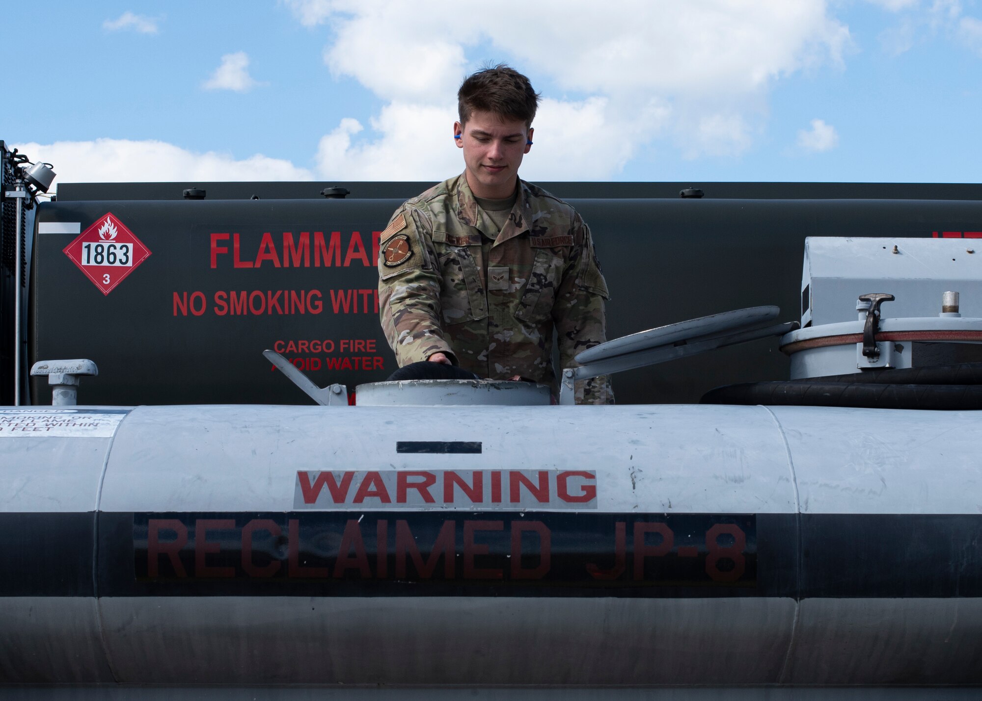U.S. Air Force Airman 1st Class Whit Brewer, 6th Logistics Readiness Squadron fuels distribution operator, reclaims jet-a fuel from a bowser with a single point nozzle hose at MacDill Air Force Base, Florida, Oct. 19, 2021. Reclaiming and reusing jet fuel from aircraft has saved MacDill more than $750,000 last quarter. (U.S. Air Force photo by Airman 1st Class Lauren Cobin)