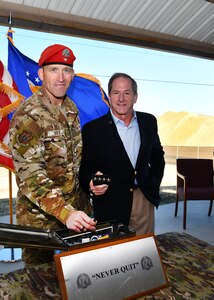 U.S. Air Force Col. Mason R. Dula (left), Special Warfare Training Wing commander, and former U.S. Air Force Chief of Staff Gen. David Goldfein (ret.) (right) hold Gen. Goldfein's velcro rank patch prior to placing it in a time capsule while standing in front of the future site of the SWTW aquatics training facility