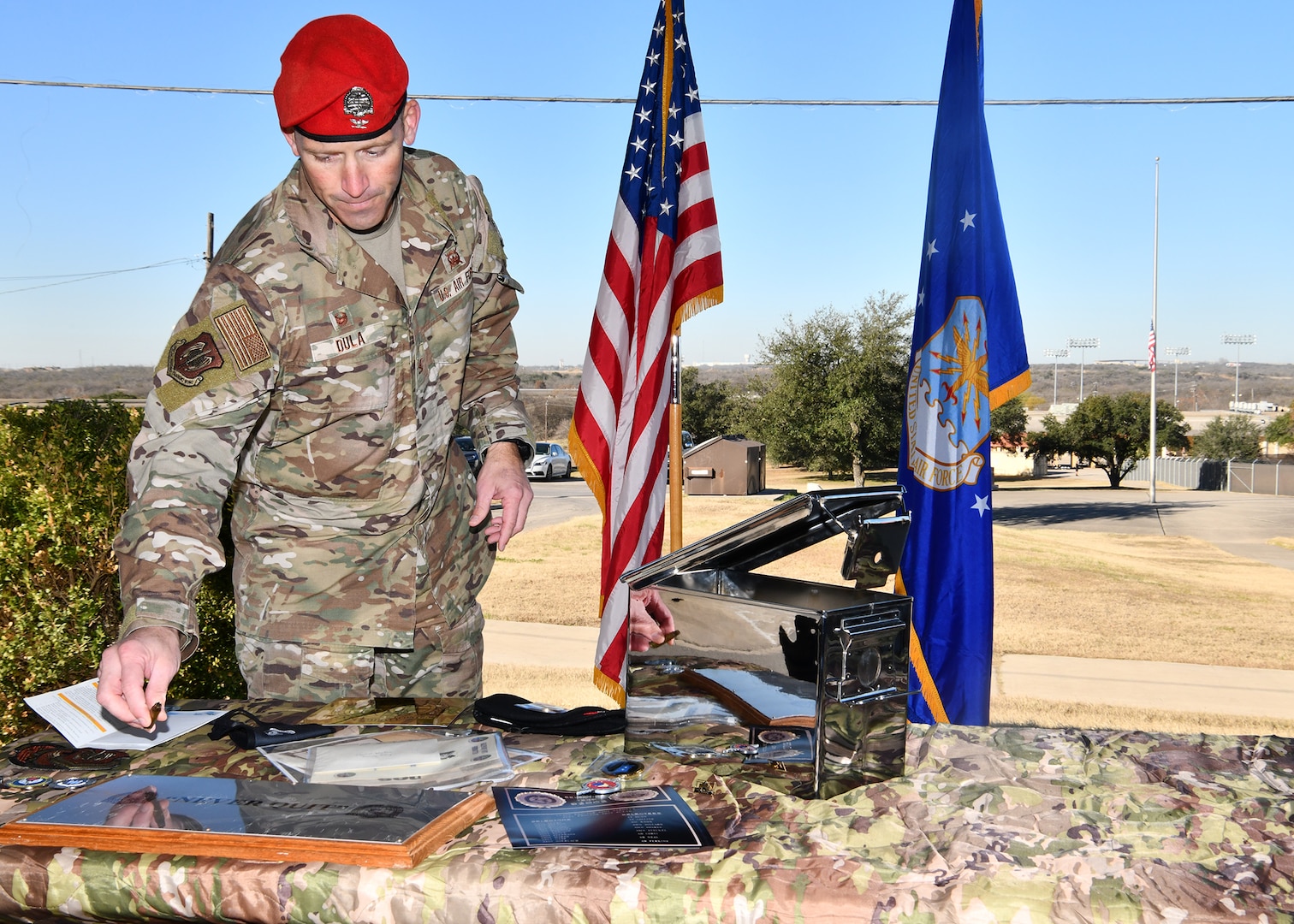 U.S. Air Force Col. Mason R. Dula, Special Warfare Training Wing commander, places a spent bullet shell prior to putting it into the SWTW aquatics training center heritage capsule while standing next to the future site of the SWTW aquatics training facility