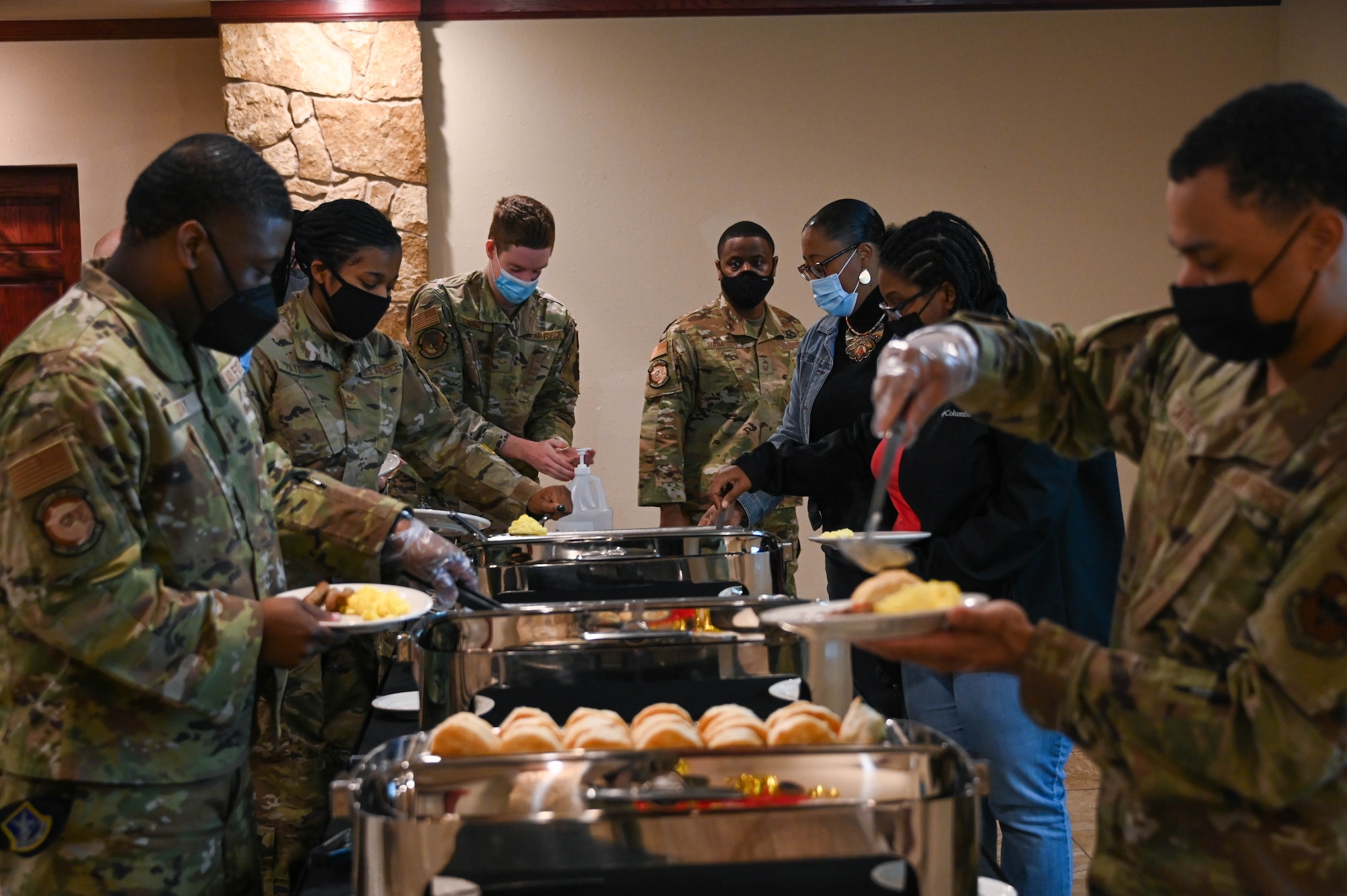 Members from the 97th Air Mobility Wing make their plates at the Martin Luther King Jr. breakfast at Altus Air Force Base, Oklahoma, January 14, 2022. The event took place in remembrance of Dr. Martin Luther King Jr. and to open discussions about how to honor Dr. King during MLK weekend. (U.S. Air Force photo by Senior Airman Kayla Christenson)